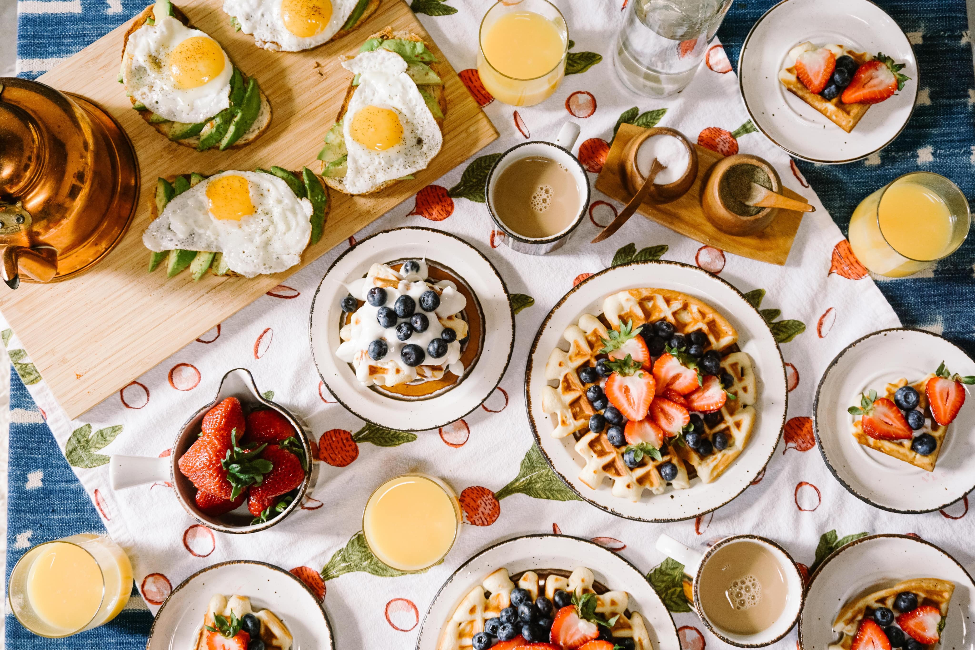  a breakfast with a combination of fruits and plates of omelettes