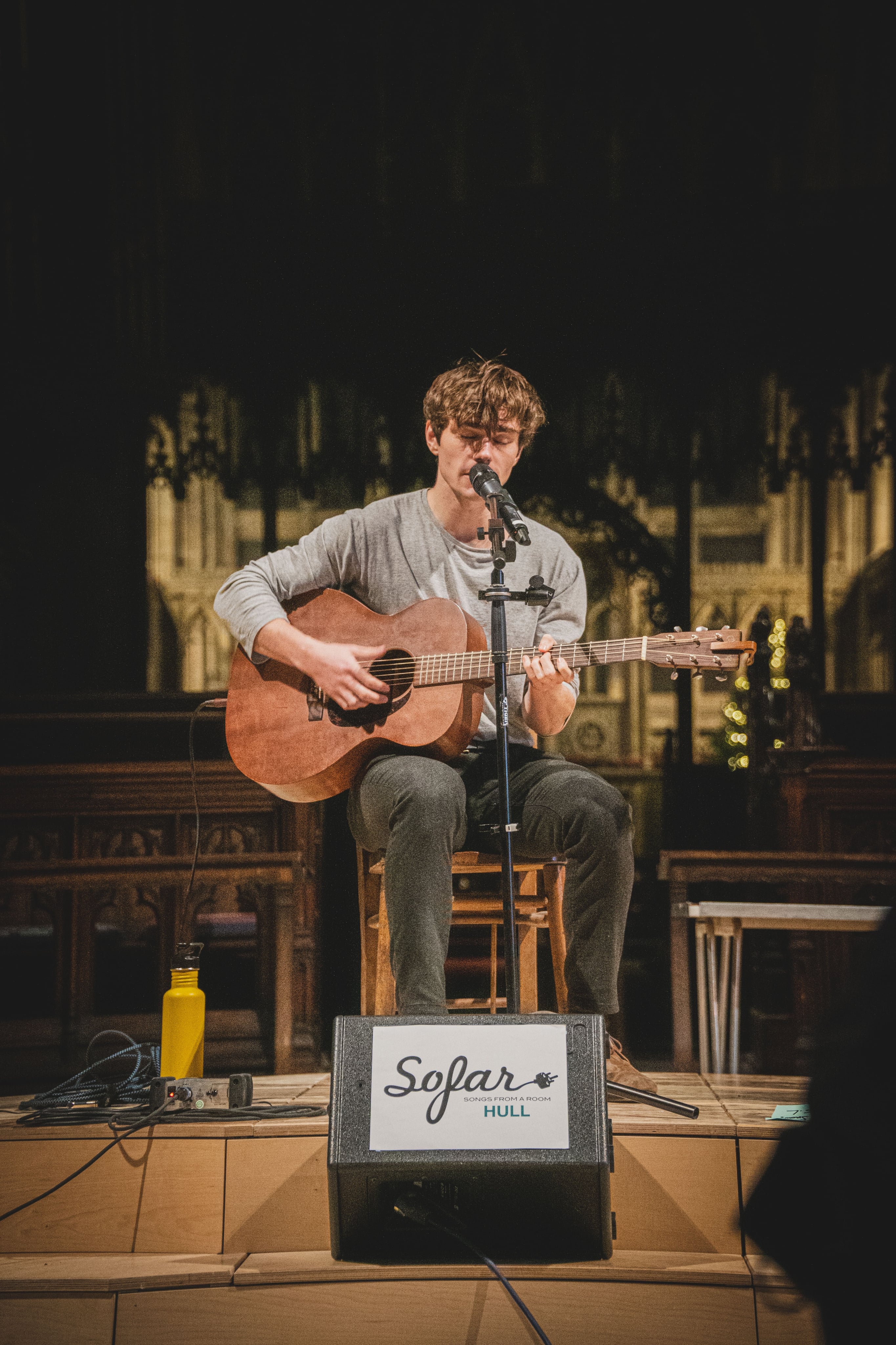 an artist performing with a guitar